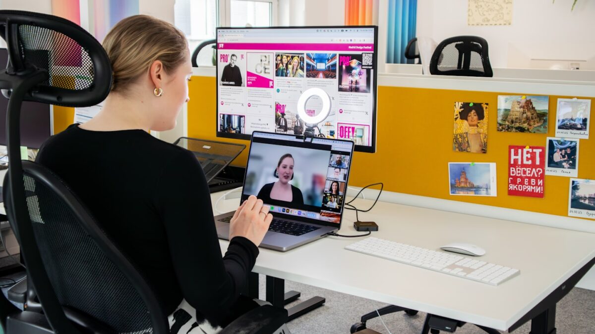 Desk planning scene showing a writer or creator organizing a reusable world structure with notes and a laptop